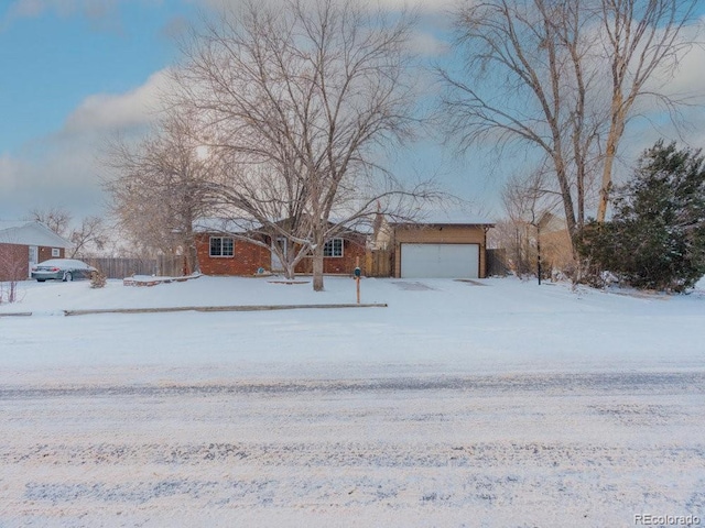 yard covered in snow featuring a garage