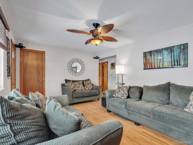 living room featuring ceiling fan and hardwood / wood-style floors