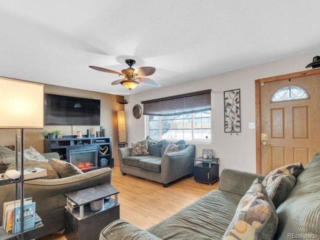 living room with ceiling fan and light hardwood / wood-style floors