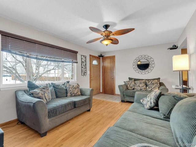 living room featuring ceiling fan and light wood-type flooring