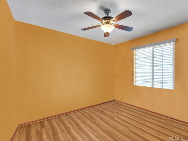 unfurnished room featuring ceiling fan and light wood-type flooring