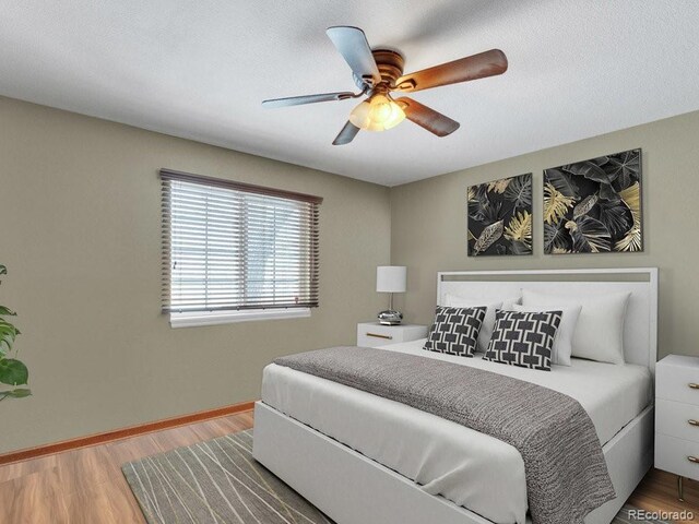 bedroom featuring hardwood / wood-style floors and ceiling fan