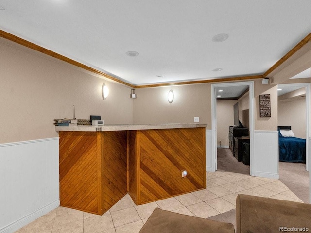 bar featuring crown molding and light tile patterned flooring