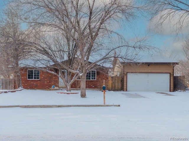 single story home with brick siding and an attached garage