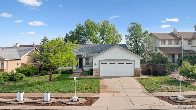 4530 Star Ridge Dr, Colorado Springs, CO 80916 - view of front facade featuring concrete driveway, a garage, and stone siding