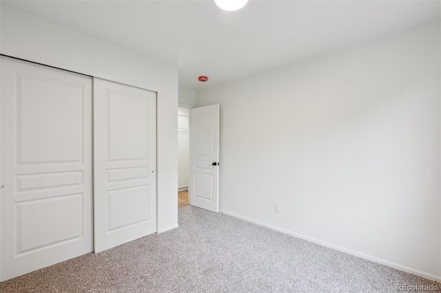 4530 Star Ridge Dr, Colorado Springs, CO 80916 - unfurnished bedroom featuring light colored carpet, a closet, and baseboards