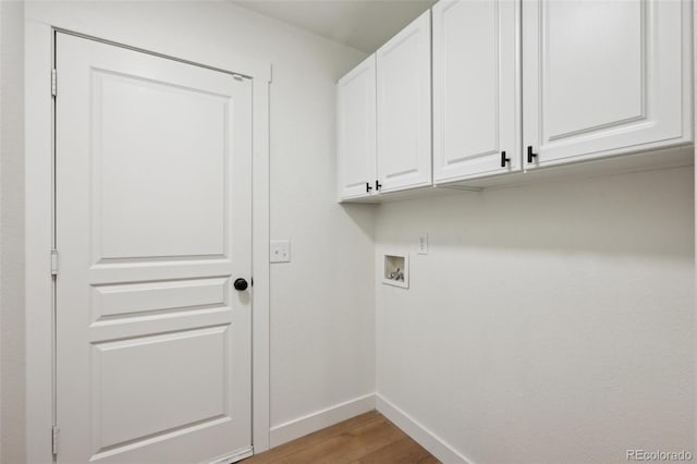 4530 Star Ridge Dr, Colorado Springs, CO 80916 - washroom with cabinet space, baseboards, washer hookup, and light wood finished floors