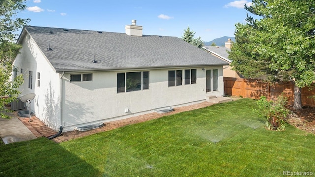 4530 Star Ridge Dr, Colorado Springs, CO 80916 - rear view of house featuring roof with shingles, a chimney, stucco siding, and a mountain view