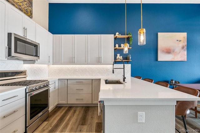 kitchen featuring white cabinets, appliances with stainless steel finishes, and a breakfast bar