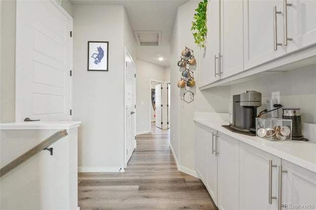 hallway with light hardwood / wood-style floors