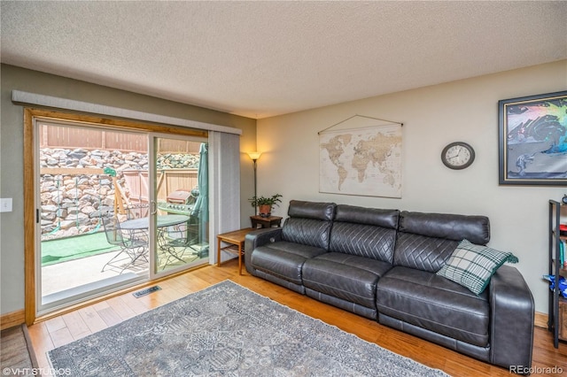 155 Xenon St Unit 33, Lakewood, CO 80228 - living room with a textured ceiling, wood finished floors, and baseboards
