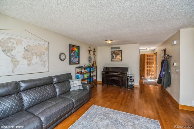 155 Xenon St Unit 33, Lakewood, CO 80228 - living area with wood finished floors, baseboards, and a textured ceiling