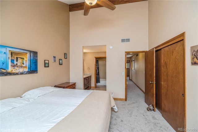 155 Xenon St Unit 33, Lakewood, CO 80228 - bedroom with light carpet, high vaulted ceiling, beamed ceiling, a closet, and baseboards