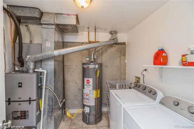 155 Xenon St Unit 33, Lakewood, CO 80228 - clothes washing area featuring gas water heater, washer and clothes dryer, and light tile patterned floors