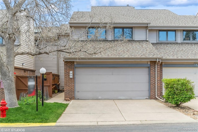 155 Xenon St Unit 33, Lakewood, CO 80228 - multi unit property with an attached garage, a shingled roof, brick siding, and concrete driveway