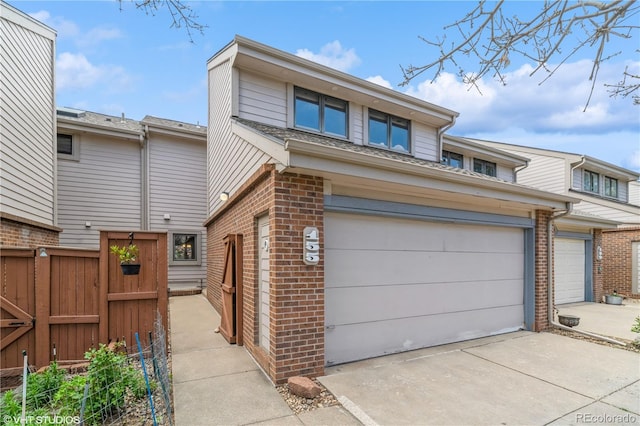 155 Xenon St Unit 33, Lakewood, CO 80228 - townhome / multi-family property featuring brick siding, fence, concrete driveway, and a garage