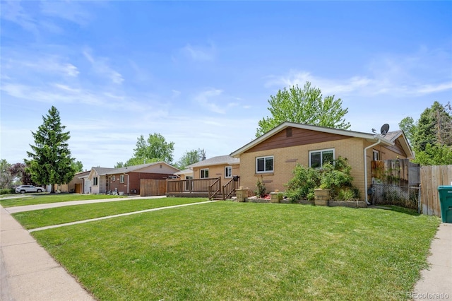 single story home with a deck and brick siding