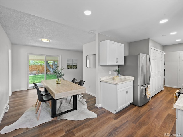 dining space with baseboards, dark wood finished floors, and recessed lighting