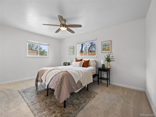 carpeted bedroom with baseboards and ceiling fan