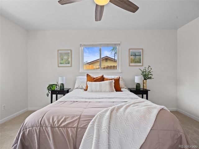 carpeted bedroom with baseboards and a ceiling fan