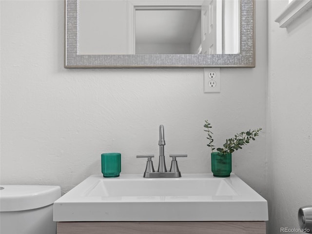 bathroom with toilet and vanity