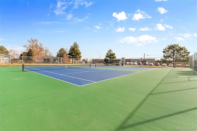 view of tennis court featuring fence