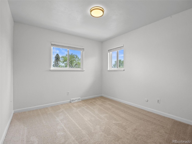 unfurnished room with baseboards and carpet flooring