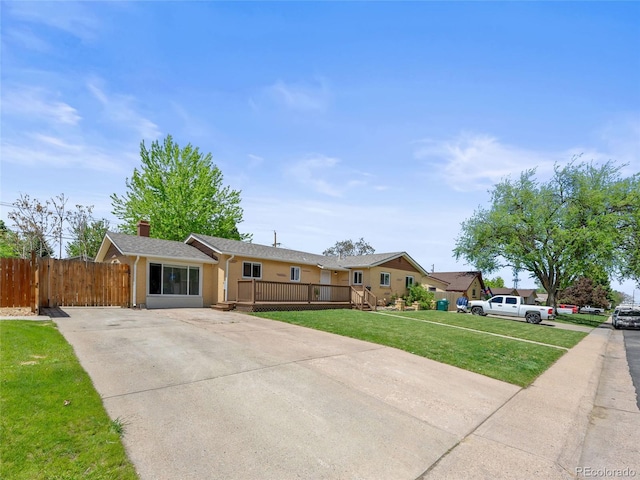 ranch-style house featuring concrete driveway and a wooden deck