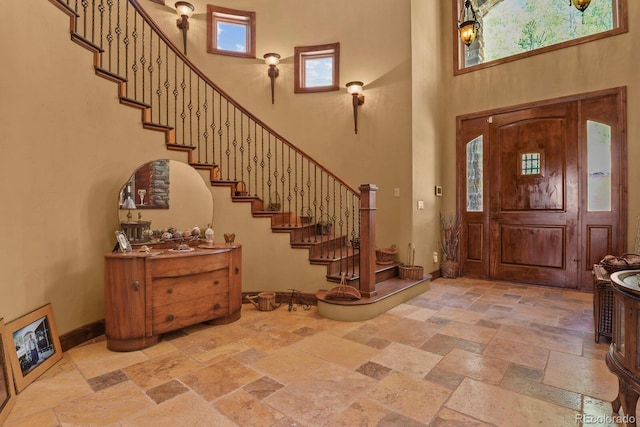 foyer entrance with a high ceiling and tile floors