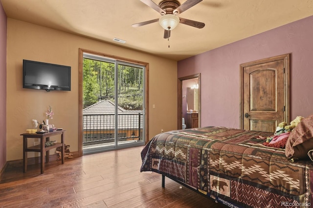 bedroom with ceiling fan, connected bathroom, hardwood / wood-style flooring, and access to exterior