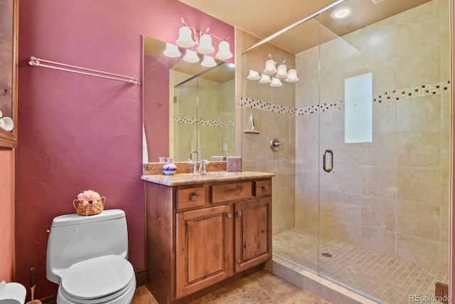 bathroom featuring a shower with door, tile flooring, vanity, and toilet