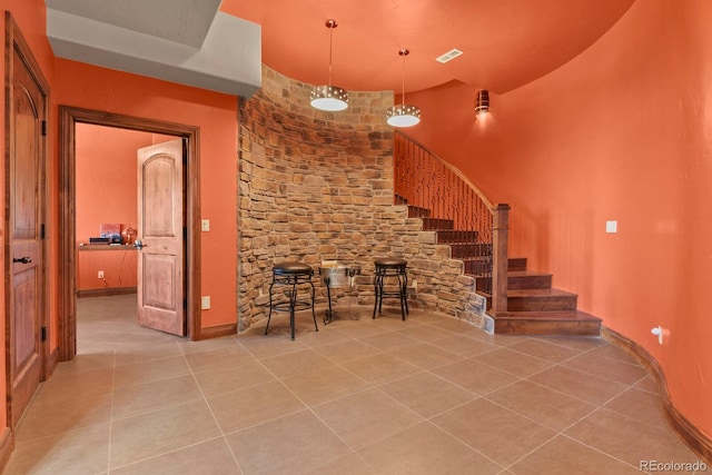 interior space featuring decorative light fixtures and tile flooring