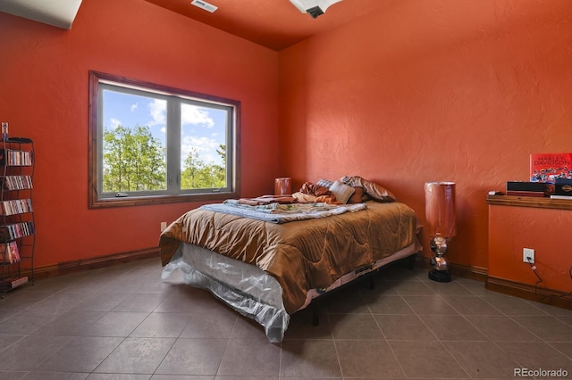 bedroom featuring dark tile flooring