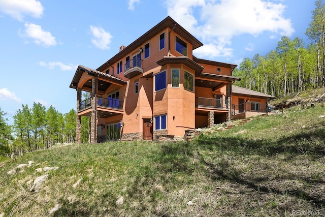 back of property featuring a balcony