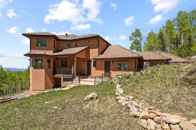 rear view of house with a patio and a lawn