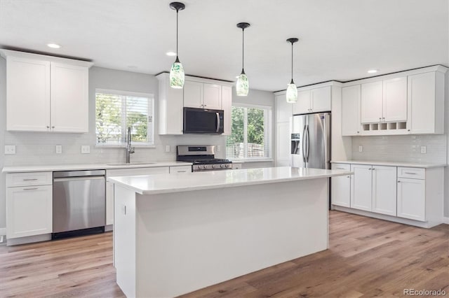 9442 W Walden Ave, Littleton, CO 80128 - kitchen featuring stainless steel appliances, backsplash, healthy amount of natural light, white cabinetry, and recessed lighting