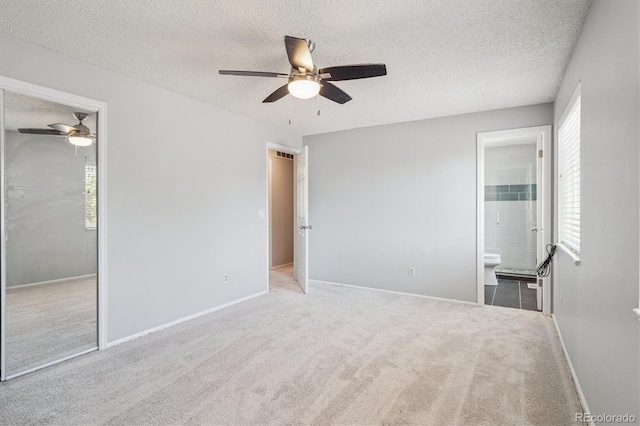 9442 W Walden Ave, Littleton, CO 80128 - unfurnished bedroom featuring a textured ceiling, carpet floors, a ceiling fan, connected bathroom, and a closet