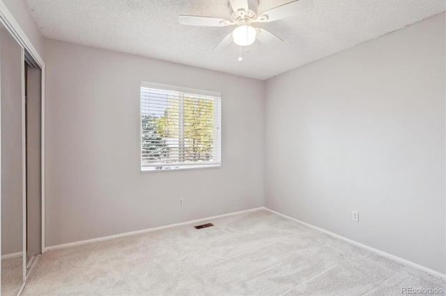 9442 W Walden Ave, Littleton, CO 80128 - unfurnished bedroom featuring carpet flooring, a textured ceiling, a closet, and a ceiling fan