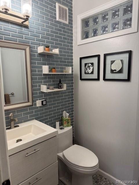 3098 W 39th Ave, Denver, CO 80211 - bathroom featuring vanity, tile walls, and backsplash