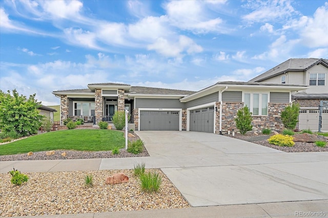9433 Torrey Way, Arvada, CO 80007 - prairie-style home with an attached garage, a front lawn, concrete driveway, stone siding, and a porch
