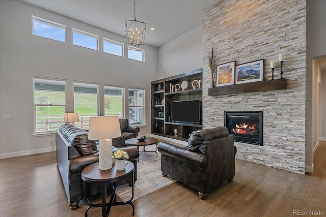 9433 Torrey Way, Arvada, CO 80007 - living area with wood finished floors, baseboards, a chandelier, plenty of natural light, and a high ceiling