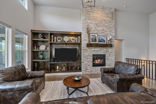 9433 Torrey Way, Arvada, CO 80007 - living room with wood finished floors, a towering ceiling, and a fireplace