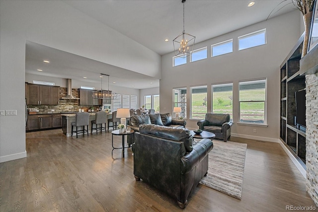 9433 Torrey Way, Arvada, CO 80007 - living area featuring a fireplace, a chandelier, dark wood-type flooring, recessed lighting, and baseboards