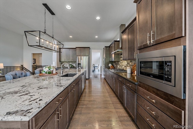 9433 Torrey Way, Arvada, CO 80007 - kitchen featuring a sink, appliances with stainless steel finishes, dark wood finished floors, tasteful backsplash, and light stone countertops