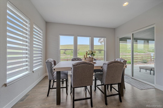 9433 Torrey Way, Arvada, CO 80007 - dining room with healthy amount of natural light, baseboards, recessed lighting, and wood finished floors