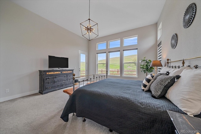 9433 Torrey Way, Arvada, CO 80007 - carpeted bedroom with a chandelier, baseboards, and a towering ceiling