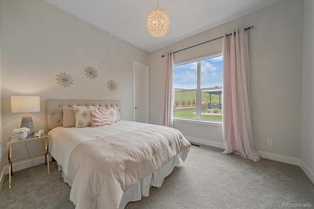 9433 Torrey Way, Arvada, CO 80007 - carpeted bedroom with baseboards and a chandelier