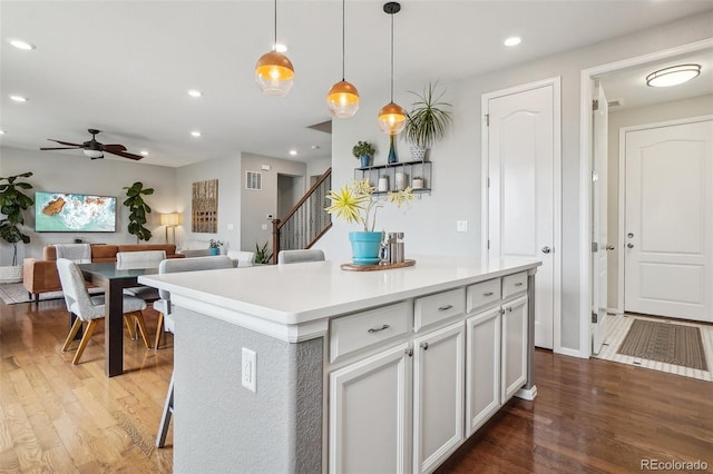 5362 E 140th Pl, Thornton, CO 80602 - kitchen with ceiling fan, white cabinets, a kitchen island, and wood finished floors