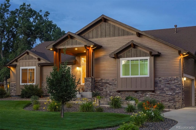 craftsman-style home with a garage and a front lawn