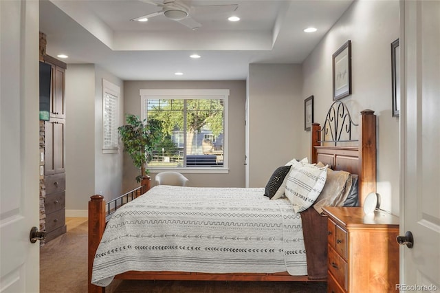 carpeted bedroom featuring a tray ceiling